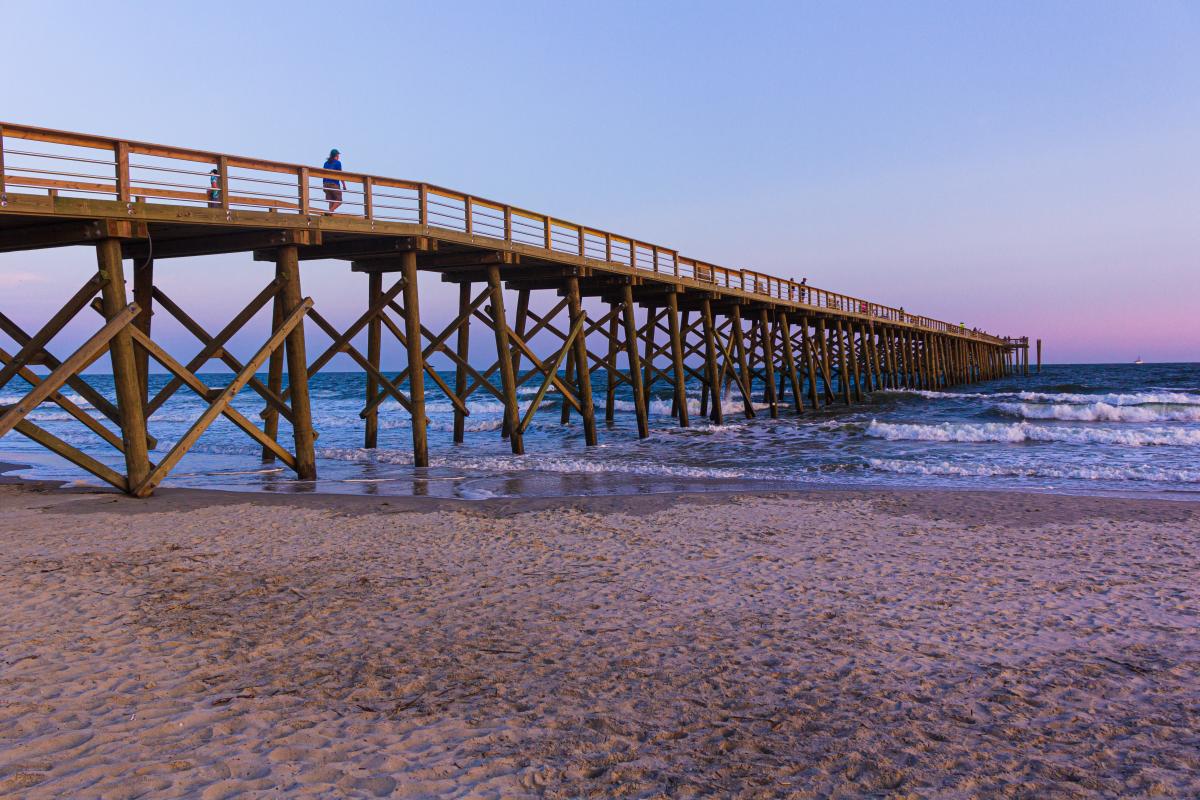 Oak Island Pier at sunset - popular fishing spot and beach landmark in Oak Island NC